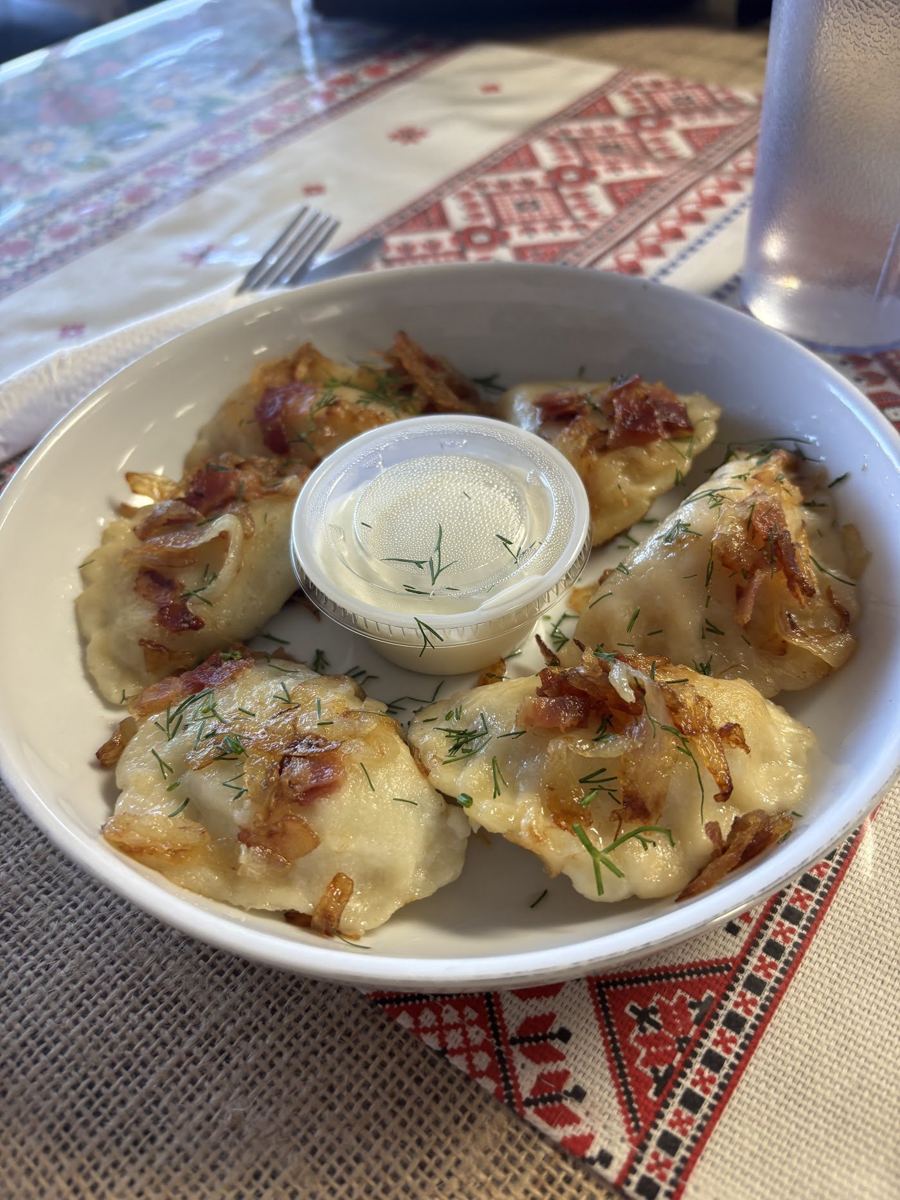 Pierogi topped with onions and sour cream