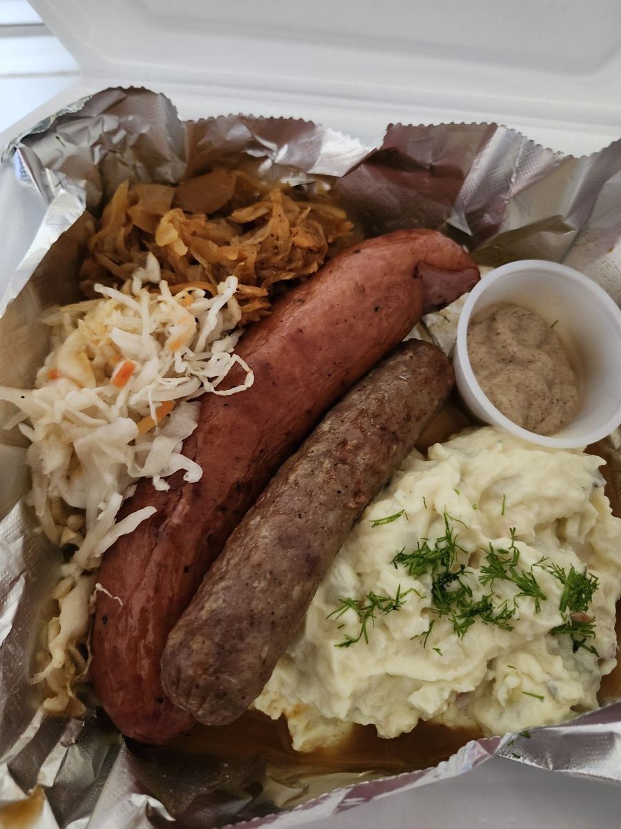 Polish sausage and bratwurst platter with sauerkraut and potato salad